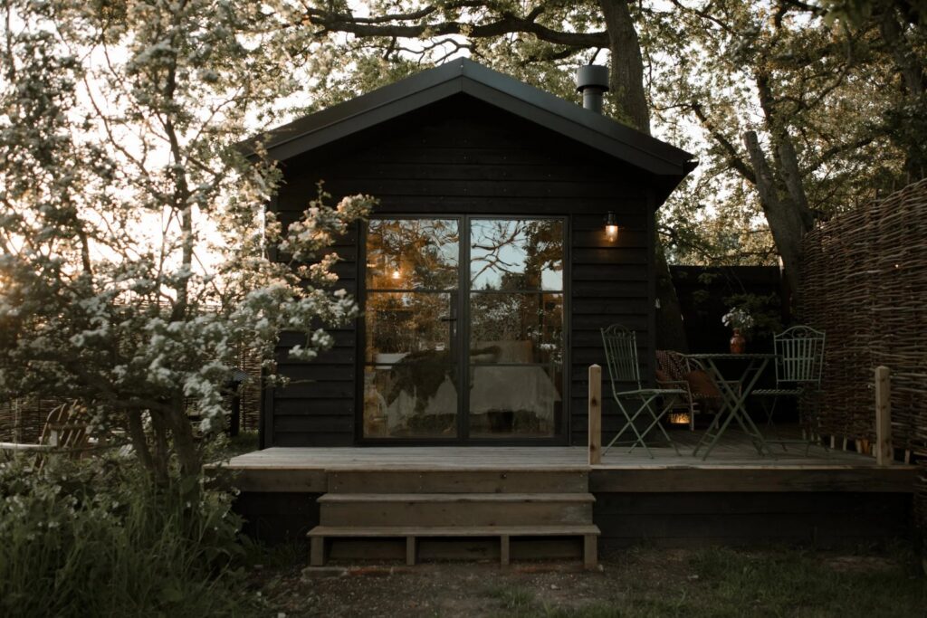 Shepherd's hut at The Lodge Essex, which has a private wild swimming lake and lakeside sauna on site